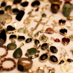 a table topped with lots of different types of jewelry